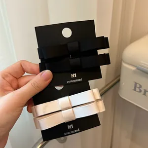 Elegante juego de pinzas para el pelo con lazo de satén en negro y crema beige
