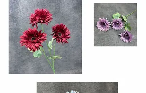 Macro detail of artificial Gerbera flowers featuring multi-layered crimson and purple petals