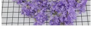 Close-up of lavender artificial cherry blossom clusters with green stems for home decor
