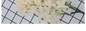 Close-up of ivory white artificial cherry blossoms with realistic fabric petals for wedding