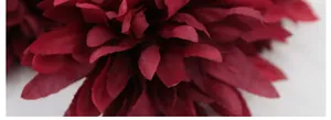 Macro detail of wine red artificial chrysanthemum with multi-layered silk fabric petals
