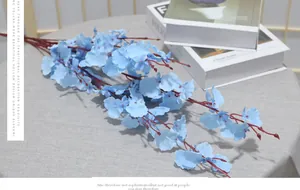 Detail of blue artificial dancing orchid with red centers on a grey textured table