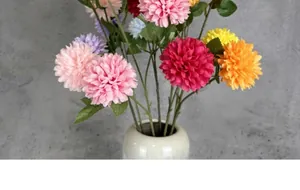 Detailed view of colorful artificial chrysanthemum flowers in a white ceramic vase