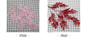 Detail von künstlichen Erdnussblättern in Rosa und Rot für Hochzeitsdekorationen