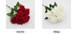 Detailed view of red and white artificial silk rose bouquets for wedding decor