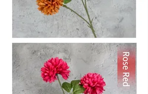 Detailed view of rose red and orange artificial pompon mums with realistic green leaves