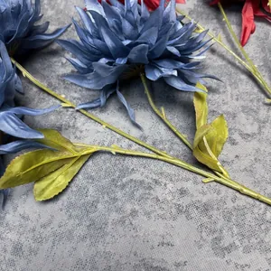 Artificial chrysanthemum bouquet with large deep blue and red silk petals in a vase