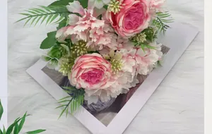 Detail showing artificial pink peonies and hydrangeas with realistic green silk leaves