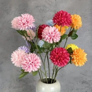 Artificial chrysanthemum bouquet with colorful pompom flowers in a white ceramic vase