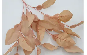 Close-up of artificial pomelo leaf branch in champagne pink for home floral decoration