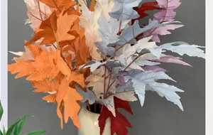 Detailed close-up of artificial oak leaves with realistic jagged edges and fall colors