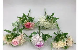 Flat lay macro of artificial peony and hydrangea silk flowers in mixed colors for decor