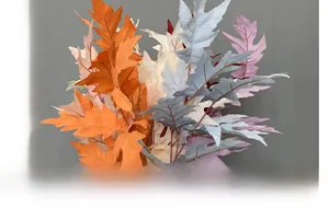 Detail of artificial serrated oak leaves with realistic textures in multiple colors