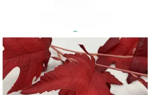 Close-up of deep red artificial oak leaves with detailed lifelike vein textures
