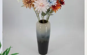Macro detail of artificial dahlia flowers in a modern gradient ceramic vase