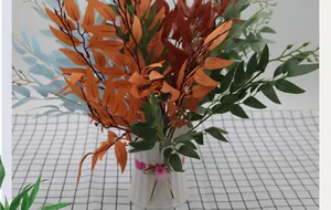 Artificial willow leaf bundle in multicolored autumn hues with a white woven vase