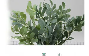 Detail of artificial eucalyptus leaves bundle with green foliage and white berries