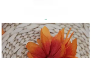 Macro detail of silk artificial dahlia petals with realistic orange gradient texture