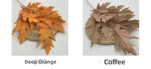 Detail view of artificial oak leaves in dark orange and coffee brown for wedding decor