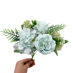 Artificial bouquet with blue peonies and green leaves for home decoration and weddings