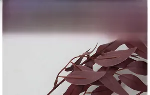 Close-up of artificial willow leaves in deep burgundy with realistic vein textures