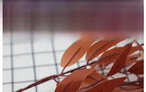 Close-up of silk willow leaves with realistic veins in vintage burnt orange autumn color