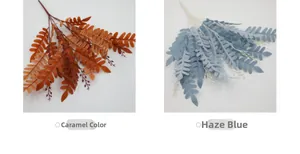 Detail of artificial locust leaves in caramel and misty blue for floral arrangements