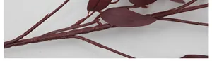 Detailed close-up of dark reddish-brown artificial willow branch with textured oval leaves