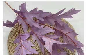 Close-up of purple artificial oak leaves with realistic jagged edges and leaf veins