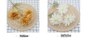 Detail view of artificial dahlia flowers in white and tawny yellow for home decoration