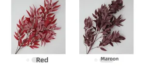 Detail view of artificial willow leaves in bright red and burgundy for home decoration
