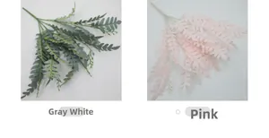 Close-up of artificial locust leaves in greyish white and pink for floral decoration