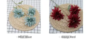 Detail of Mist Blue and Deep Red artificial dahlia stems with three flower heads and green leaves