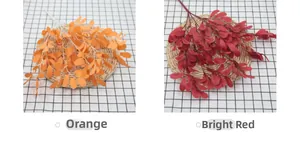 Detail of artificial peanut leaves in bright orange and deep red for home decor