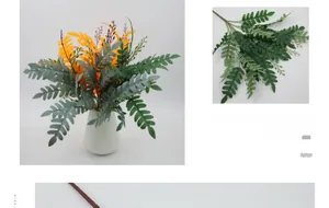 Detail of faux fern leaves in a white ceramic vase for home and office decoration