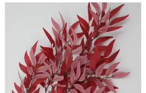 Detailed close-up of artificial willow leaves with red and pink gradient for decor