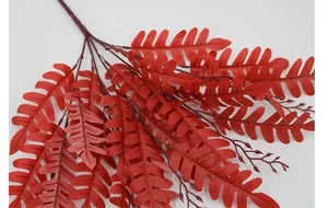 Detailed close-up of dark red artificial fern leaves with realistic feathery texture