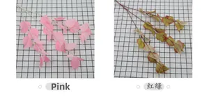 Detail of faux bodhi leaves in pink and red-green gradient on long slender stems