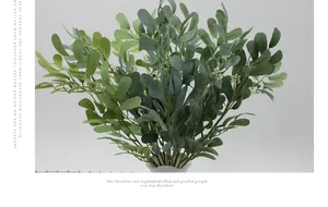 Detailed view of artificial peanut leaves with green foliage and white flower buds