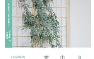 Detail of lifelike grey-green willow leaf vines draped over a minimalist wooden screen