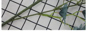 Close-up of artificial Oncidium orchid stems showing grey-blue flowers and dark green petals