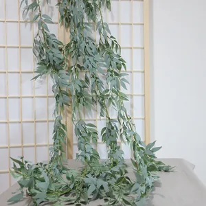 Artificial gray-green willow leaf vine hanging on a wooden screen for home decoration