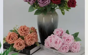Close-up of pink Austin roses and peonies with silk petals and realistic green leaves