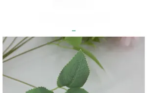 Detailed close-up of realistic green artificial rose leaves with clear veins and serrated edges