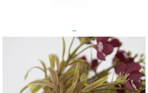 Detailed view of dark red silk hydrangea petals with realistic texture and green leaves