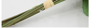 Detail of olive green artificial daisy stems tied with fiber rope and a clear plastic tie