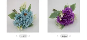 Detail of blue and purple artificial African daisies with realistic petals and green leaves