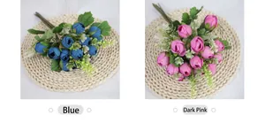 Detail of silk mini rose buds in blue and deep pink with realistic green leaves
