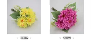 Detail of fuchsia and yellow artificial gerbera daisies with realistic petals and leaves
