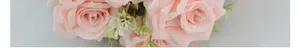 Macro detail of artificial silk Austin roses in light pink with realistic green leaves
